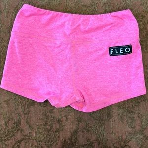 Heathered neon pink Fleo workout shorts.